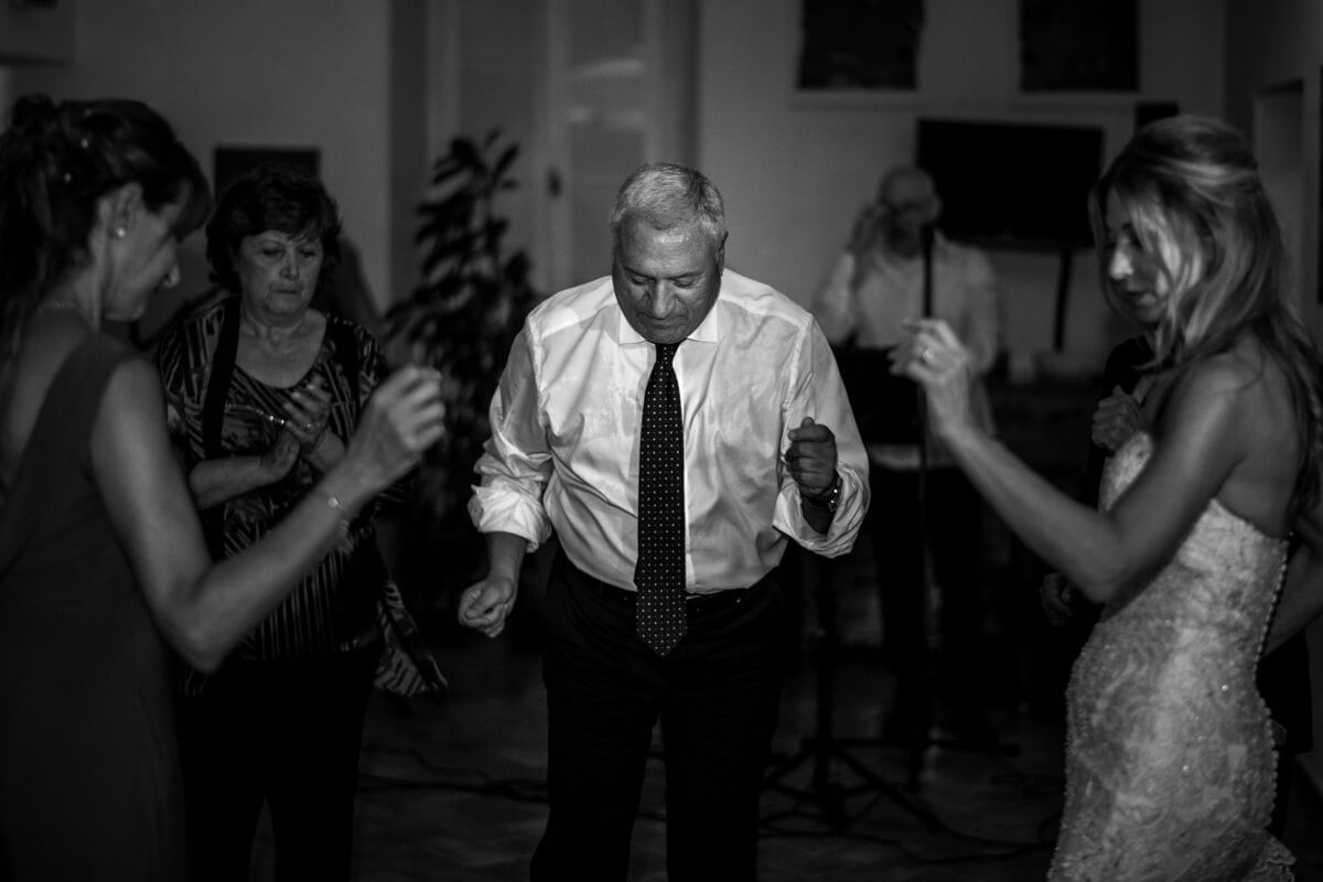 il testimone balla divertito con gli invitati alla festa del ricevimento del matrimonio